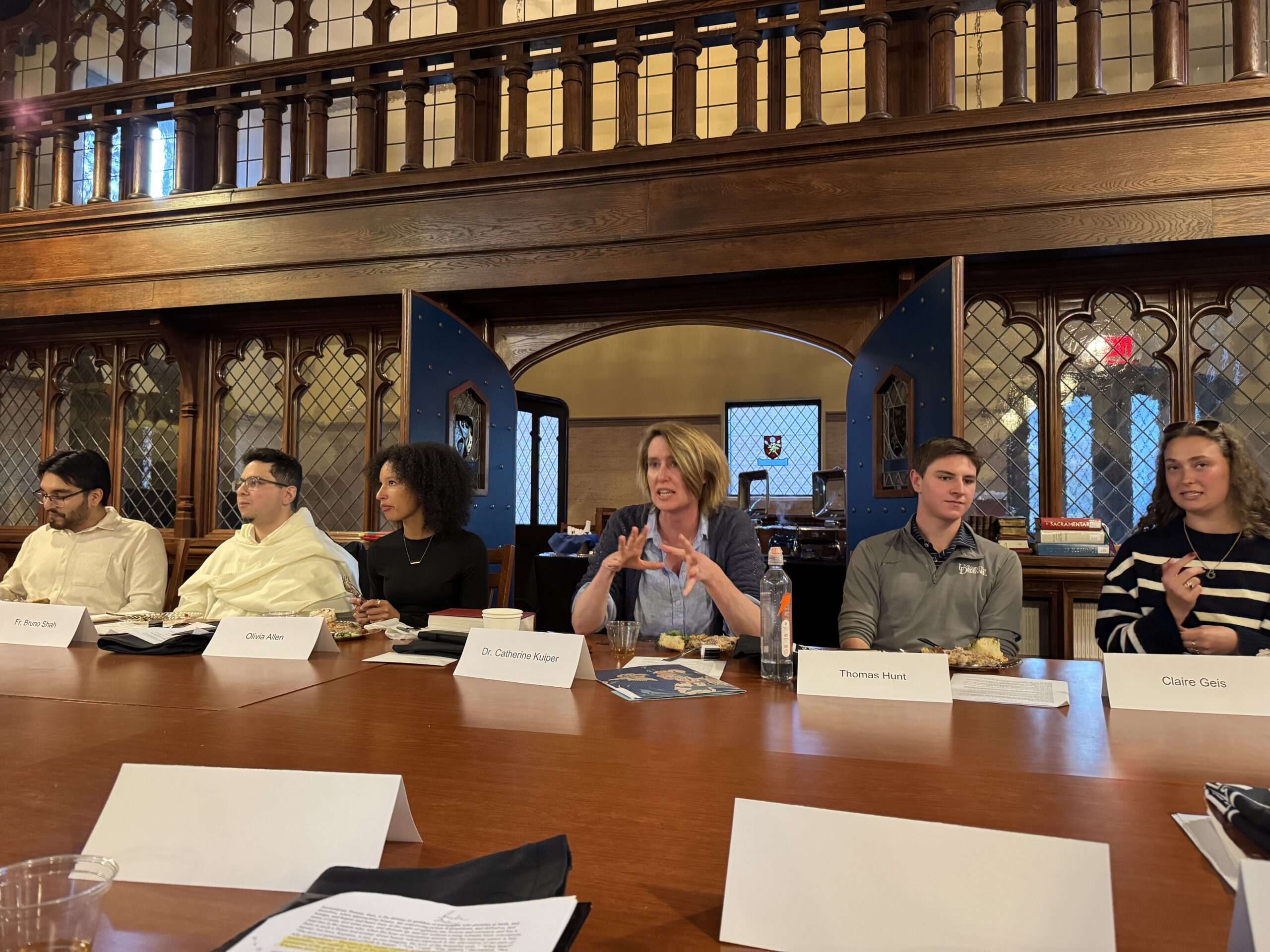 An image of half the table while participants engage in intellectual discourse.