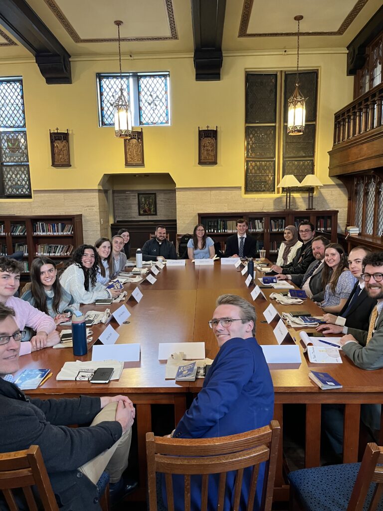 Students seated around a seminar table in the Center for Catholic and Dominican Studies